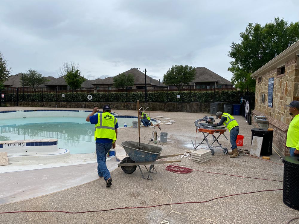 Arrow Construction workers working on a pool deck